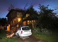 A tree fell on a car and house in the 1100 block of Argyle Road in Windsor, Ontario following heavy evening thunderstorms on May 26, 2015. The unidentified resident was home at the time, but was uninjured when the tree crashed through the upper level. (JASON KRYK/The Windsor Star)