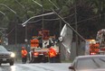 Crews work to right a utility pole on Tecumseh Road East at Walker Road following a thunderstorm on May 26, 2015. Windsor Police diverted traffic in the eastbound lanes of Tecumseh Road and Windsor Fire Service assisted on the scene.    (JASON KRYK/The Windsor Star)