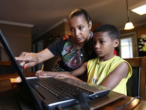 Thousands of Ontario parents pulled their children out of public schools this week in protest of sexual education curriculum introduced by the province. Tammy Moore is shown with her son Jordan Moore, at their Amherstburg, ON. home. Tammy Moore and her husband Greg chose to keep their children away from school. (DAN JANISSE/The Windsor Star)