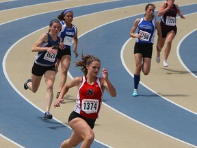 Kelly Hodgins leads the pack in the 200m at the SWOSSAA track meet at Alumni Field in Windsor on Thursday, May 21, 2015. (TYLER BROWNBRIDGE/The Windsor Star)