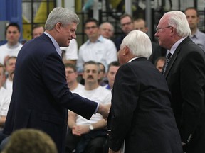 Prime Minister Stephen Harper, left, shakes hands with Mike Solcz and Len Solcz at the Valiant plant in Windsor on Thursday, May 14, 2015. (Nick Brancaccio / The Windsor Star)