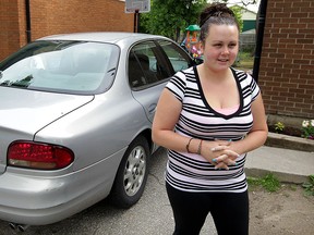 Amy Fish, 25, with her recovered Oldsmobile June 1, 2015.  Fish's vehicle was stolen from her Curry Avenue driveway after she left her keys in the front door lock.  Months later, by a stroke of luck, Fish spotted her car park at Windsor Regional Hospital's Met campus. (NICK BRANCACCIO/The Windsor Star).
