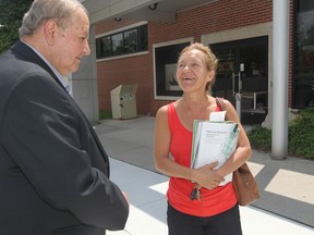 Windsor city Coun. Ed Sleiman, left, speaks with Doris Bolla as she leaves the Windsor Public Library Seminole Branch on Seminole Street in Windsor, Ont., on June 9, 2015. (JASON KRYK/The Windsor Star)