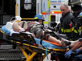 A man is taken by Essex-Windsor EMS paramedics after being trapped underneath a Ford Fusion which crashed into a medical clinic at 5105 Tecumseh Road East June 8, 2015. Several others suffered minor injuries.  Windsor Police, Windsor firefighters assisted at the scene.  (NICK BRANCACCIO/The Windsor Star).