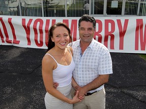Ashley Crow, left, said "Yes" when Marco D'Antonio proposed using a large banner placed on the ground so she could see it while flying in a plane last Saturday. With assistance from Windsor Flying Club, Ashley and Marco took flight where the banner was unveiled on the ground just as the engagement ring was presented to Ashley during their flight. (NICK BRANCACCIO/The Windsor Star).