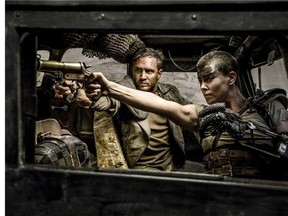 Tom Hardy, center, as Max Rockatansky and Charlize Theron, right, as Imperator Furiosa in Warner Bros. Pictures' and Village Roadshow Pictures' action adventure film, "Mad Max:Fury Road," a Warner Bros. Pictures release. (Jasin Boland/Warner Bros. Pictures via AP)