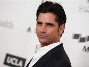 FILE - This April 25, 2015, file photo shows actor John Stamos arriving at the 4th Annual Reel Stories, Real Lives Benefit in Los Angeles. Stamos has been arrested and cited with driving under the influence in Beverly Hills. Beverly Hills police say they received calls around 7:45 p.m. Friday, June 12, 2015, reporting a possible drunk driver. Police later stopped Stamos, who was the only person in the vehicle. Police say Stamos was taken to a hospital because of a possible medical condition. (Photo by Richard Shotwell/Invision/AP, File)