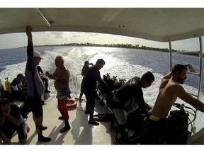 In this June 10, 2015 frame grab taken from video, diving enthusiasts travel on a boat for a dip at the International diving Center Maria la Gorda on the Guanahacabibes peninsula in the province of Pinar del Rio, Cuba. (AP Photo/Chris Gillette)