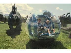 This photo provided by Universal Pictures shows, Nick Robinson, left, as Zach, and Ty Simpkins as Gray, in a scene from the film, "Jurassic World," directed by Colin Trevorrow, in the next installment of Steven Spielberg's groundbreaking "Jurassic Park" series. (ILM/Universal Pictures/Amblin Entertainment via AP)