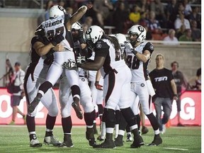 Ottawa Redblacks' Jeremiah Johnson, left, celebrates with teammates after scoring a touchdown against the Montreal Alouettes during second half CFL football action in Montreal on June 25, 2015. As the CFL looks to gain a younger audience in Canada, the league is most popular with Americans under 35, a new survey suggests. THE CANADIAN PRESS/Graham Hughes