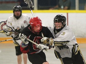 Windsor Clippers Josh Jubenville presses Wallaceburg Red Devils Alex Taylor during second period Ontario Jr. B Lacrosse action at Forest Glade Arena on June 10, 2015. (JASON KRYK/The Windsor Star)