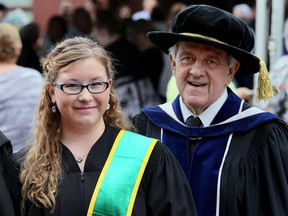 Catherine Caron, left, overcame devastating injuries from a car crash in January 2014 to walk across the stage during the 48th convocation for St. Clair College, the last one to be performed by the college's outgoing president Dr. John Strasser, right, at St. Clair College's Capitol Theatre in Chatham, Ont. on Saturday June 20, 2015. (Diana Martin, The Daily News)