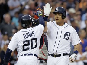 Detroit Tigers' Miguel Cabrera receives a high-five from Rajai Davis (20) after hitting a three-run home run against the Cleveland Indians during the sixth inning of a baseball game Friday, June 12, 2015, in Detroit. (AP Photo/Duane Burleson)