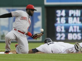 Detroit Tigers' Anthony Gose steals second as Cincinnati Reds second baseman Brandon Phillips bobbles the throw during the first inning of a baseball game, Monday, June 15, 2015, in Detroit. (AP Photo/Carlos Osorio)