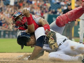 Detroit Tigers' Anthony Gose is tagged out by Cincinnati Reds catcher Brayan Pena at home during the fifth inning of a baseball game, Tuesday, June 16, 2015, in Detroit. The play was challenged but upheld. (AP Photo/Carlos Osorio)