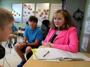 Barbara Arrowsmith Young, right, engages with students Alex Scott, left, and Noah Sulaiman at their classroom auditory work station at Lakeview Montessori Thursday June 18, 2015.  (NICK BRANCACCIO/The Windsor Star).