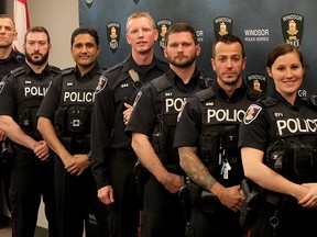 Heroic Windsor Police officers Brad Snyder, left, Jeffery Dalpe, Surjeet Gill, Mark Kloppenburg, Adam Spinarsky, Anthony Smith and Kandice Scott, right, received special acknowledgement from Windsor Police Services Board for their exceptional work saving area citizens from a burning home. Constable Warren Levack also received praise for his efforts. Photo taken June 2, 2015. (NICK BRANCACCIO/The Windsor Star).