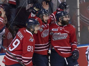 Oshawa Generals forward Anthony Cirelli, centre, is joined by teammates Sam Harding, left, and Bradley Latour, right, after he scored his team's first goal against Kelowna Rockets during second period action at the Memorial Cup final in Quebec City on Sunday, May 31, 2015. THE CANADIAN PRESS/Jacques Boissinot
