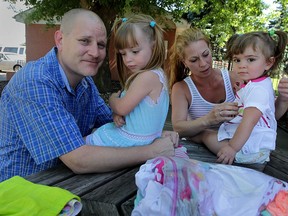 Raymond Letendre, left, and Rebecca Fitch with their daughters Kya, 3, and Aiyana, 19-months, at a local motel where they're trying to re-group following a fire which destroyed most of their belongings Tuesday June 23, 2015  (NICK BRANCACCIO/The Windsor Star).