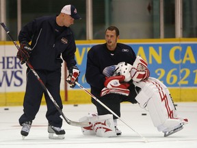 Spitfires goalie Andrew Engelage, right, chats with goalie coach Bill Dark during practice at Windsor Arena in 2008. (DAN JANISSE/The Windsor Star)