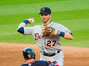 Shortstop Andrew Romine #27 of the Detroit Tigers throws out Michael Brantley #23 of the Cleveland Indians at first as Jason Kipnis #22 is out at second for a double play to end the third inning at Progressive Field on June 23, 2015 in Cleveland, Ohio. (Photo by Jason Miller/Getty Images)