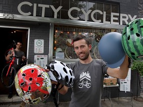 Looking at this selection, there's no reason not to wear a trendy bicycle helment.  Oliver Swainson of City Cyclery displays a variety of bicycle helmets Thursday June 25, 2015. Swainson holds a Nutcase Boogie, left, Catlike Racer style, Sahn equestrian style and Nutcase Watermelon, right. (NICK BRANCACCIO/The Windsor Star).