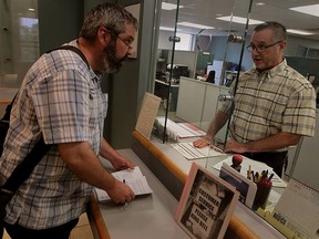 Paul Synnott files application for a review of campaign finances of candidate Gabriel Maggio with Chuck Scarpelli at City Clerk's office Thursday June 25, 2015. (NICK BRANCACCIO/The Windsor Star)