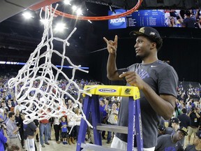 Duke's Justise Winslow cuts down part of the net  after a college basketball regional final game against Gonzaga in the NCAA Tournament Sunday, March 29, 2015, in Houston. Duke won 66-52 to advance to the Final Four. (AP Photo/Charlie Riedel)