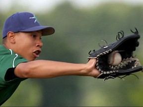 Pitcher Noah Richardson of Windsor Selects U15 snags a line drive by LaSalle Titans U14 at Villanova High School June 29, 2015. (NICK BRANCACCIO/The Windsor Star).