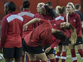 Canada's Selenia Iacchelli (back) and Carmelina Moscato joke during a training session at the Olympic Stadium in Montreal on June 14, 2015 on the eve of the team's 2015 FIFA Women's World Cup Group A match against the Netherlands. (NICHOLAS KAMM/AFP/Getty Images)