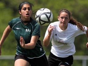 Batoul Ajrouche from Lajeunesse, left battle St. Thomas's Mica Davidson-Hunt during girls OFSAA Soccer action at McHugh Park in Windsor, Ontario. (JASON KRYK/The Windsor Star)