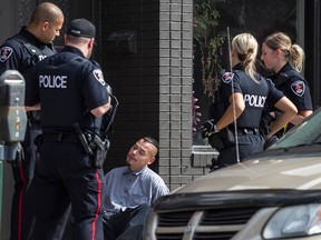 WINDSOR, ONT.: JUNE 21, 2015 -- A man is taken into custody by Windsor police for uttering threats at the 1300 block of Wyandotte St. E., Sunday, June 21, 2015.  (DAX MELMER/The Windsor Star)