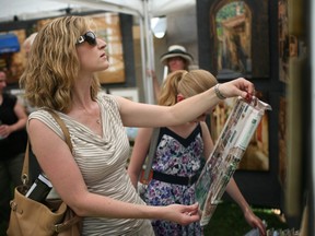 In this file photo, Kelly Dixon, with her daughter, Lindsay Dixon, browse through works of photography from Shirley Brigden Photography at Art in the Park, Saturday, June 7, 2014. This year, the annual arts and crafts show takes place Saturday, June 6 from 10 a.m. to 7 p.m. and Sunday, June 7 from 10 a.m. to 5 p.m. (DAX MELMER/The Windsor Star)