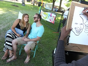 Luciana Verardi and Tom Hoffman get their portrait sketched by Hanan from Art Art Illustrations at Art in the Park, Saturday, June 6, 2015.  (DAX MELMER/The Windsor Star)