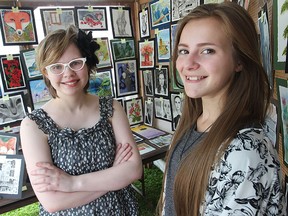 Walkerville high school artists Bailey Girard, left, and Delaney Beaudoin showcase their work during the Art in the Park exhibit on Sunday, June 7, 2015. (DAX MELMER/The Windsor Star)