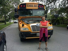Lydia Balcair stands in front of a school bus in front of her Walkerville home. She said the idling engines are disturbing local residents. Wednesday June 17,2015. (JOHN DOHERTY/The Windsor Star).