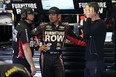 LONG POND, PA - JUNE 05:  Martin Truex Jr., driver of the #78 Furniture Row/Visser Precision Chevrolet, center, speaks with crew chief Cole Pearn, right, and a crew member in the garage area during practice for the NASCAR Sprint Cup Series Axalta "We Paint Winners" 400 at Pocono Raceway on June 5, 2015 in Long Pond, Pennsylvania.