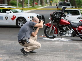 Windsor police investigate after a motorcycle and a minivan collided at the intersection of Richmond Street and Chilver Road in Windsor on Thursday, June 4, 2015.               (TYLER BROWNBRIDGE/The Windsor Star)