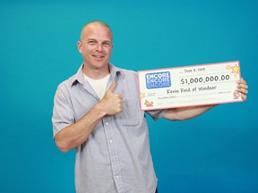 Windsor's Kevin Reid holds his cheque for $1 million that he won with ENCORE after playing LOTTO MAX on June 5, 2015. (Courtesy of OLG)