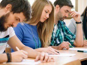 Young students having a test in a classroom. Photo by fotolia.com.