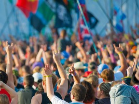 Fans cheering at rock festival. Photo by fotolia.com.
