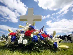 A wreath on the grave of Walter J. Gunther Jr, from the Massachusetts 101 airborn division, who died on June 6, 1944,  at the Colleville American military cemetery, in Colleville sur Mer, western France, Saturday June 6, 2015, on  the 71st anniversary of the D-Day landing. D-Day marked the start of a Europe invasion, as many thousands of Allied troops began landing on the beaches of Normandy in northern France in 1944 at the start of a major offensive against the Nazi German forces, an offensive which cost the lives of many thousands. (AP Photo/Remy de la Mauviniere)