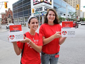 The Heart and Stroke Foundation hit the streets on Thursday, June 25, 2015, to create awareness and collect donations for Stroke Awareness Month. They were handing out educational material during the campaign. Celina Trudell (L) and Sarah Longeuay are shown in downtown Windsor, ON. (DAN JANISSE/The Windsor Star)