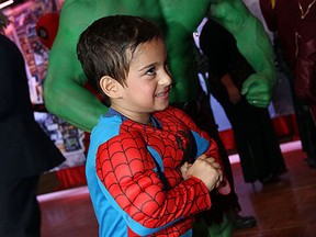 Young Aidan Khan and Ken Dannison show off their muscles at the Heroes and Villains gala in support for the Art Gallery of Windsor at the St. Clair Centre for the Arts in Windsor on Friday, June 12, 2015.               (TYLER BROWNBRIDGE/The Windsor Star)