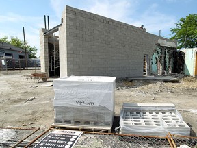 A bricklaying crew works on the former Five Star Oil auto repair shop at Windsor on Tuesday, June 2, 2015. It has been nearly three years since a fire gutted the building.                (TYLER BROWNBRIDGE/The Windsor Star)
