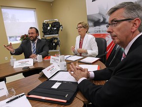 Ontario Premier Kathleen Wynne visited with members of the Automotive Parts Manufacturers Association on Friday, June 19, 2015, at the Magna Closures in Windsor, ON. Wynne is shown with APMA president Flavio Volpe (L) and member Barry Jones. (DAN JANISSE/The Windsor Star)