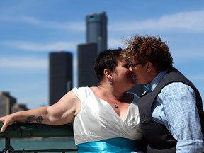 Mel Kania, left, and her wife Lynnette kiss on their wedding day on Windsor's riverfront. On Friday June 26, the United States Supreme Court ruled same-sex couple have the constitutional right to marry. (Courtesy of Chris Mailloux)