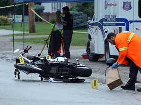 LaSalle police investigate at the scene of a motorcycle accident on Todd Lane on Wednesday, June 17, 2015. The driver of the motorcycle was seriously hurt in the crash.                  (TYLER BROWNBRIDGE/The Windsor Star)