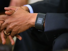 U.S. President Barack Obama wears a Fitbit Surge watch while talking to members of the news media in the Oval Office at the White House May 29, 2015 in Washington, DC.  (Getty Images files)