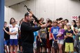Const. Larry Hartley demonstrates several firearms during VIP Day at the Tilston Armoury in Windsor on Wednesday, June 9, 2015. Grade six students were invited to participate in the event. Values, Influence and Peers is an education program delivered to students which features members of the K-9 unit, ESU, emergency disposal and firearms unit.               (TYLER BROWNBRIDGE/The Windsor Star)